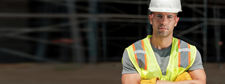 Construction worker with arms crossed