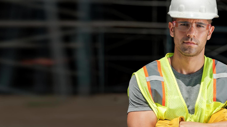 Construction worker with arms crossed