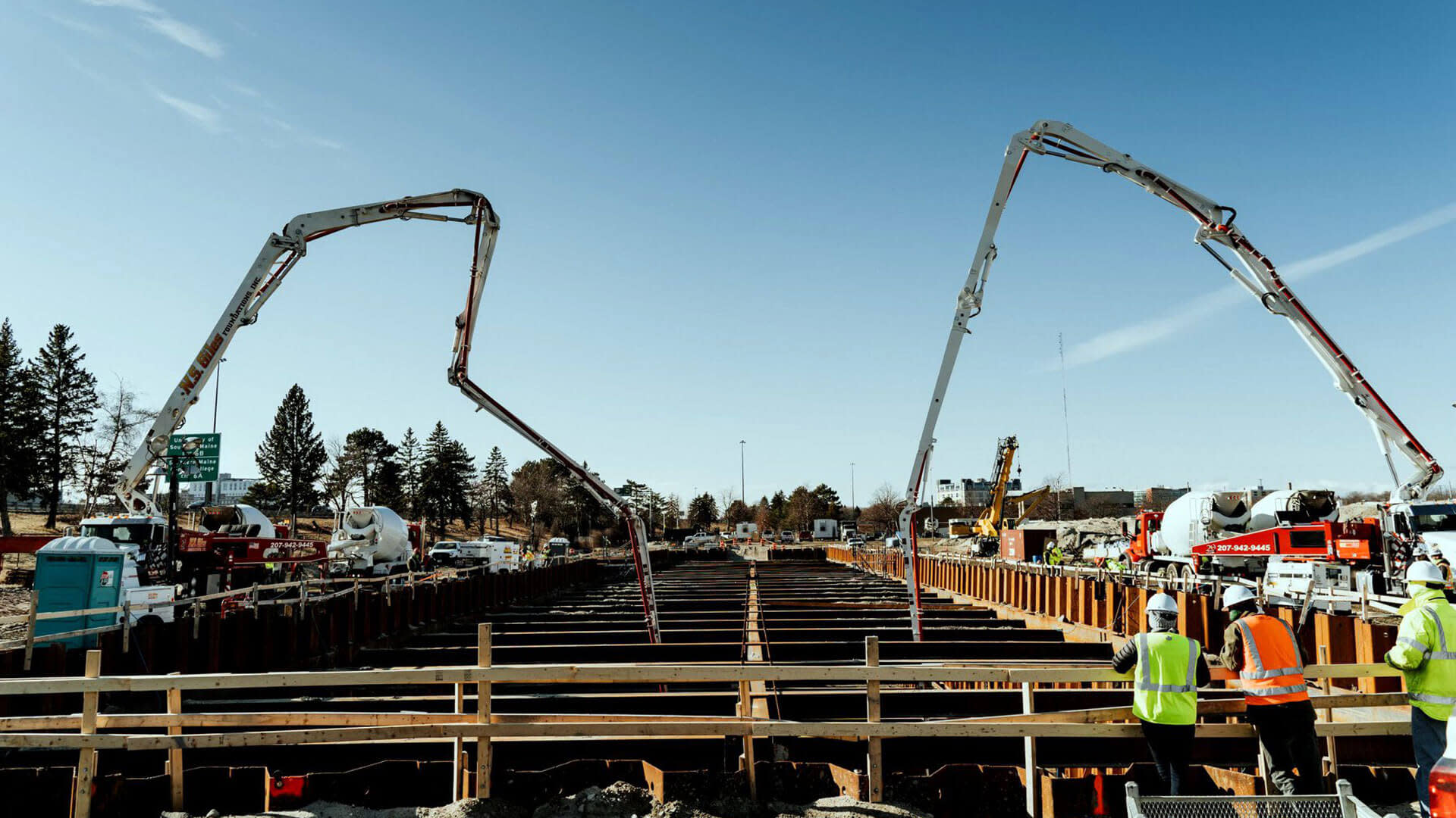 Machines pumping concrete into the construction site