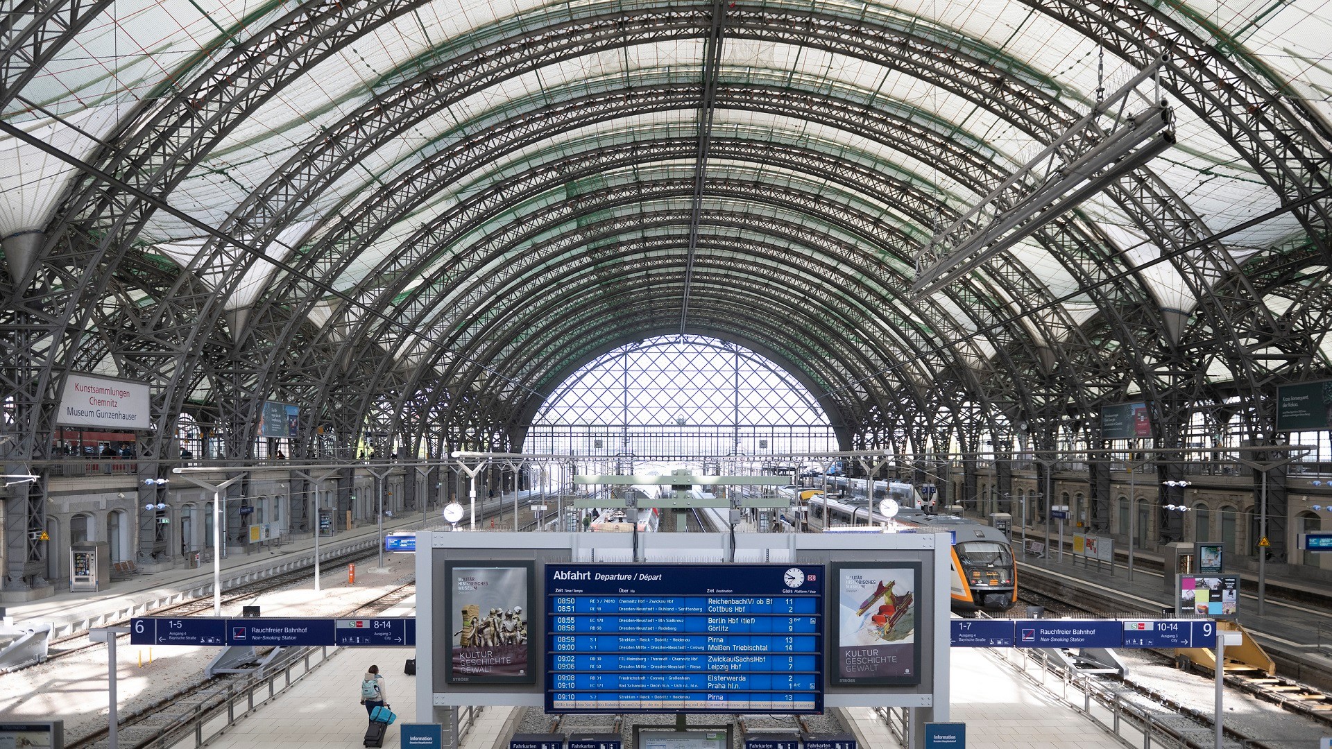 A train station with a sign and a train track