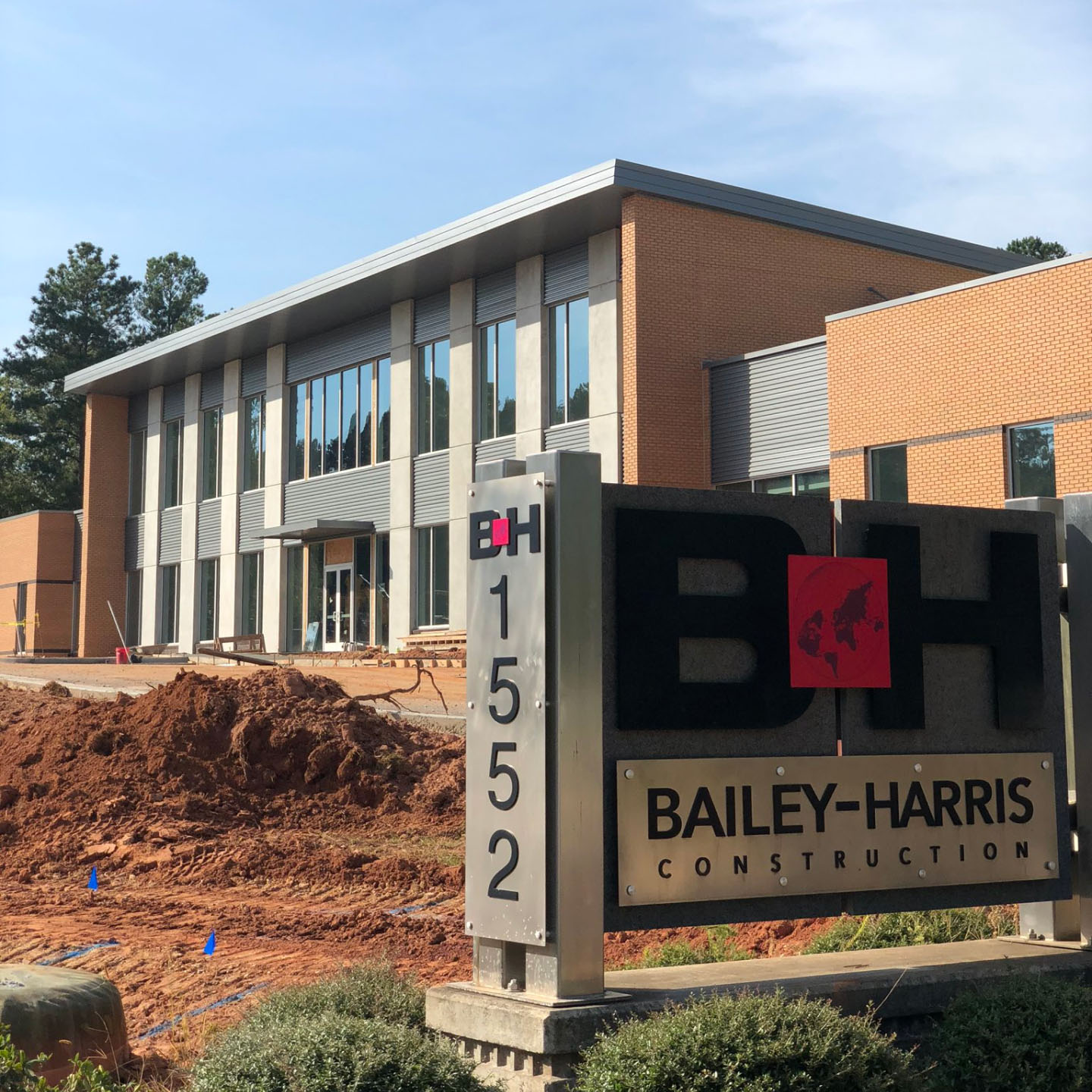 A sign for Bailey Harris Construction Company displayed prominently in front of a building