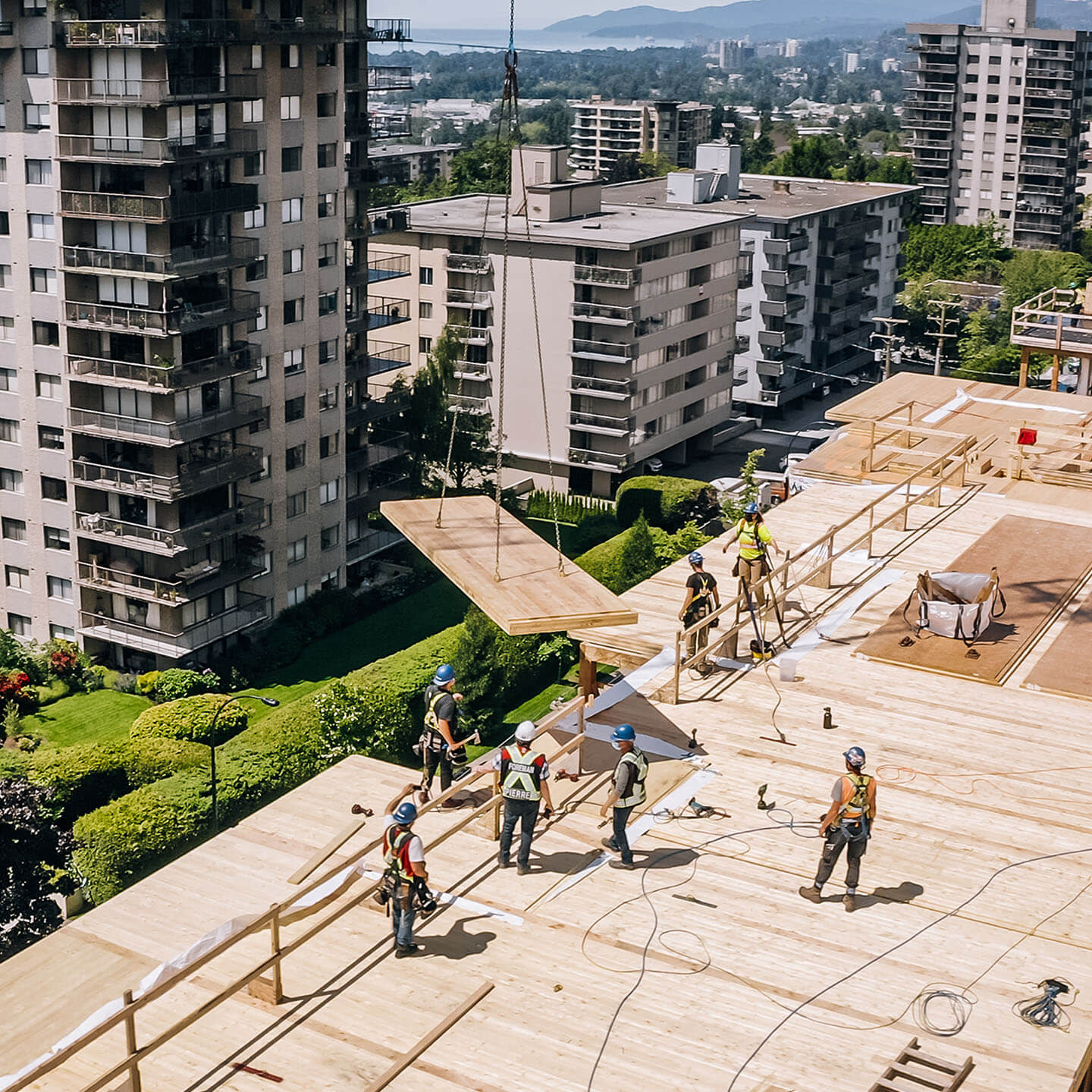 Construction workers standing on top of a building