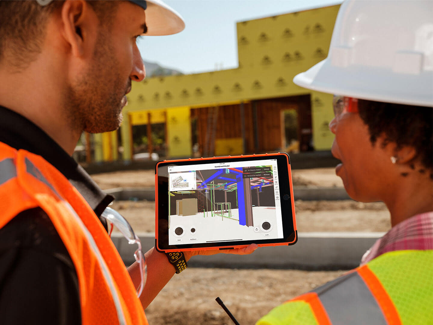 Workers going over BIM plans on a construction site