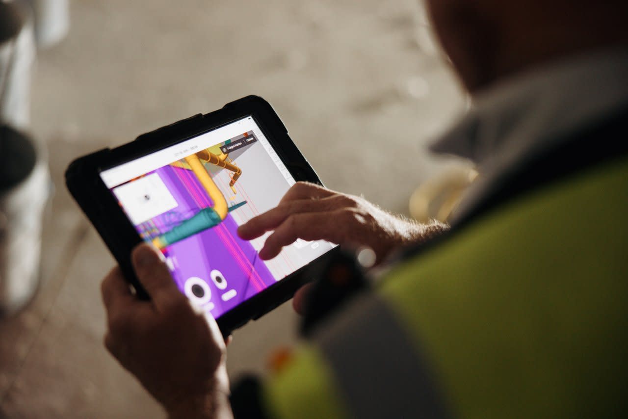 Close up of a construction worker using BIM on a tablet