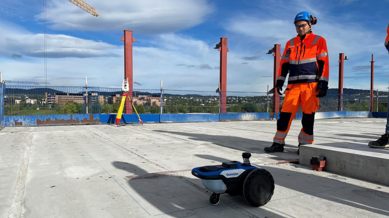 A construction worker standing on an unfinished roof