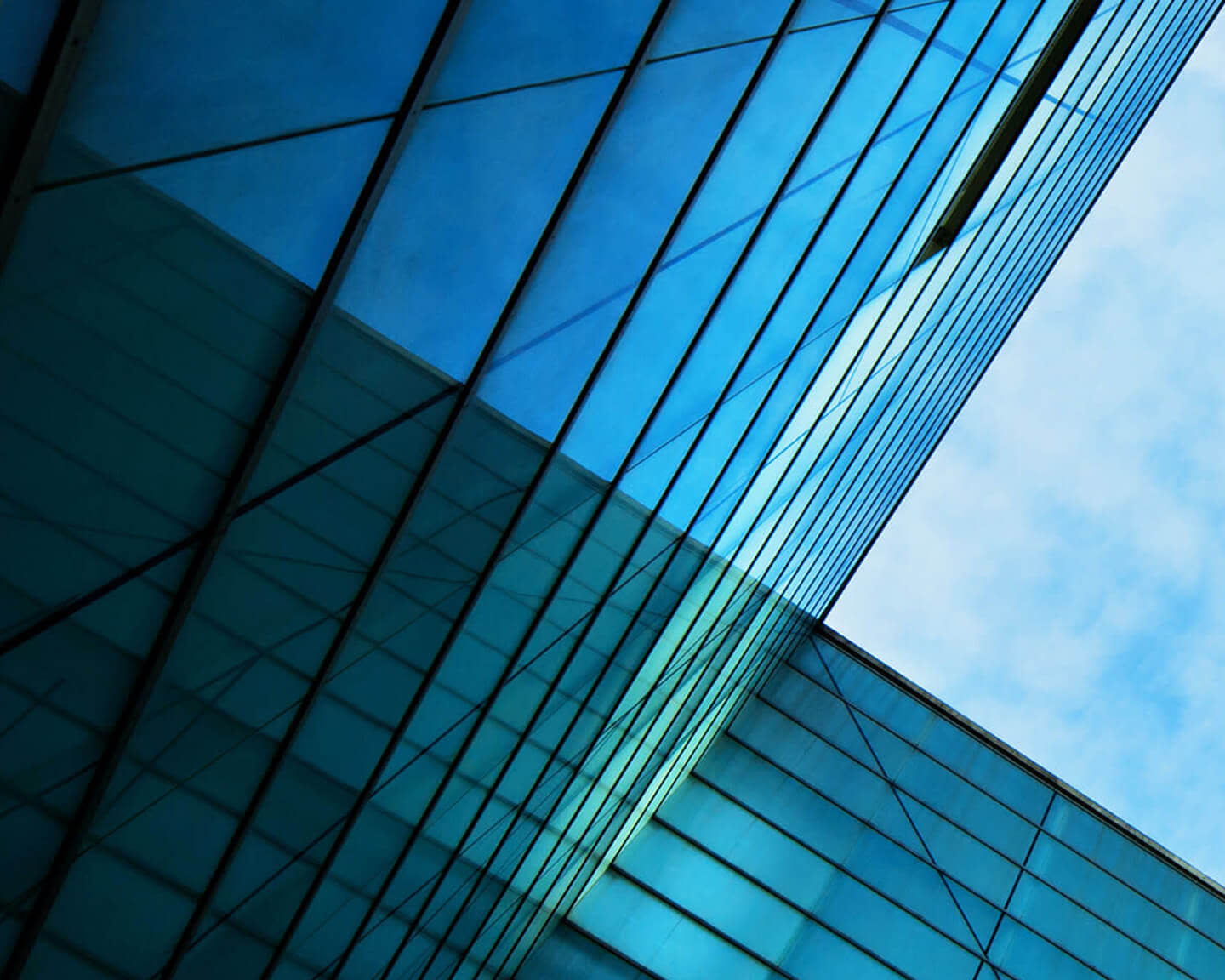 A reflective glass building seen from a low angle