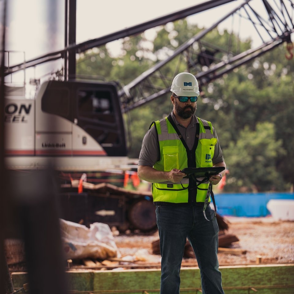 A construction worker standing outside of a construction area