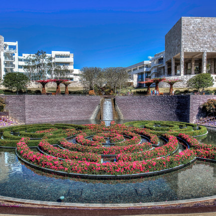 a circular fountain with flowers in it