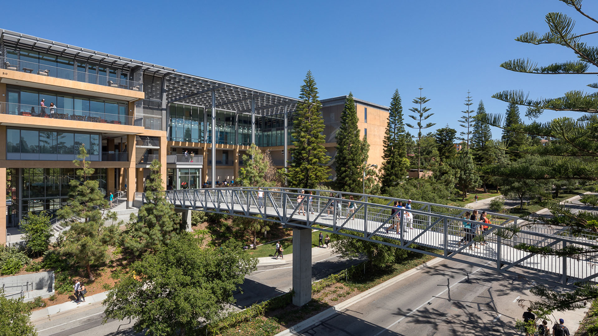 a bridge over a road with people walking on it