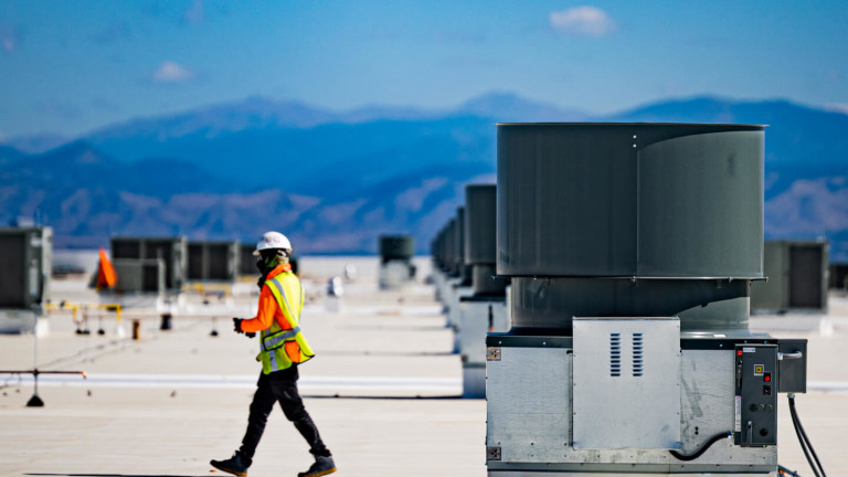 Construction worker walking on a rooftop