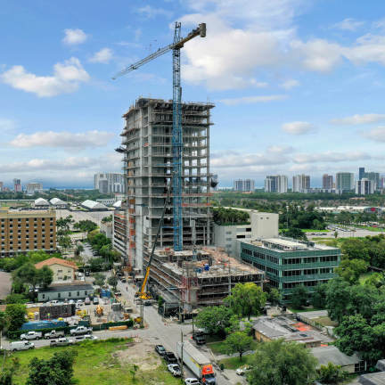 Aerial view of building under construction overlooking the city