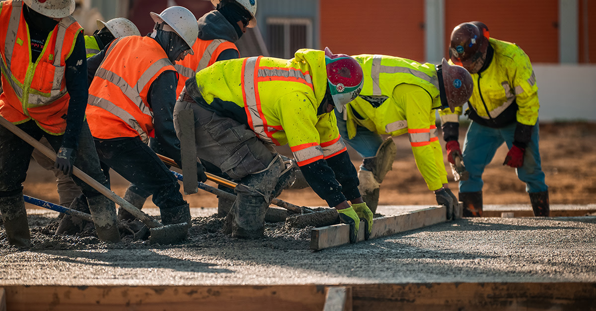 construction workers smoothing concrete