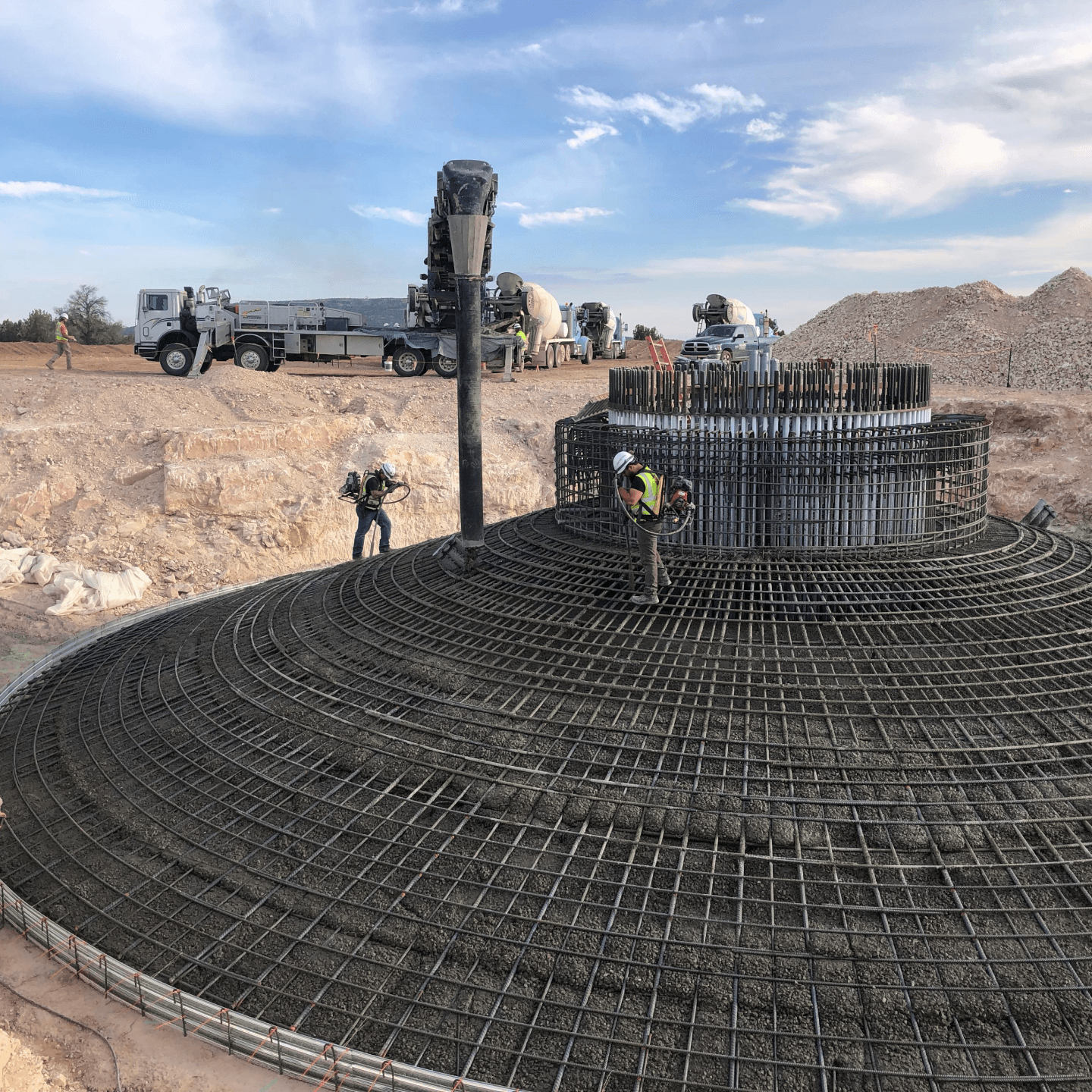 construction site with workers working on a round structure