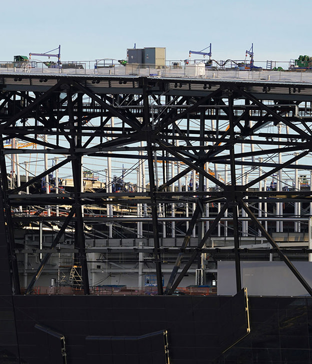 Industrial port crane and steel bridge structure with cargo equipment against clear sky