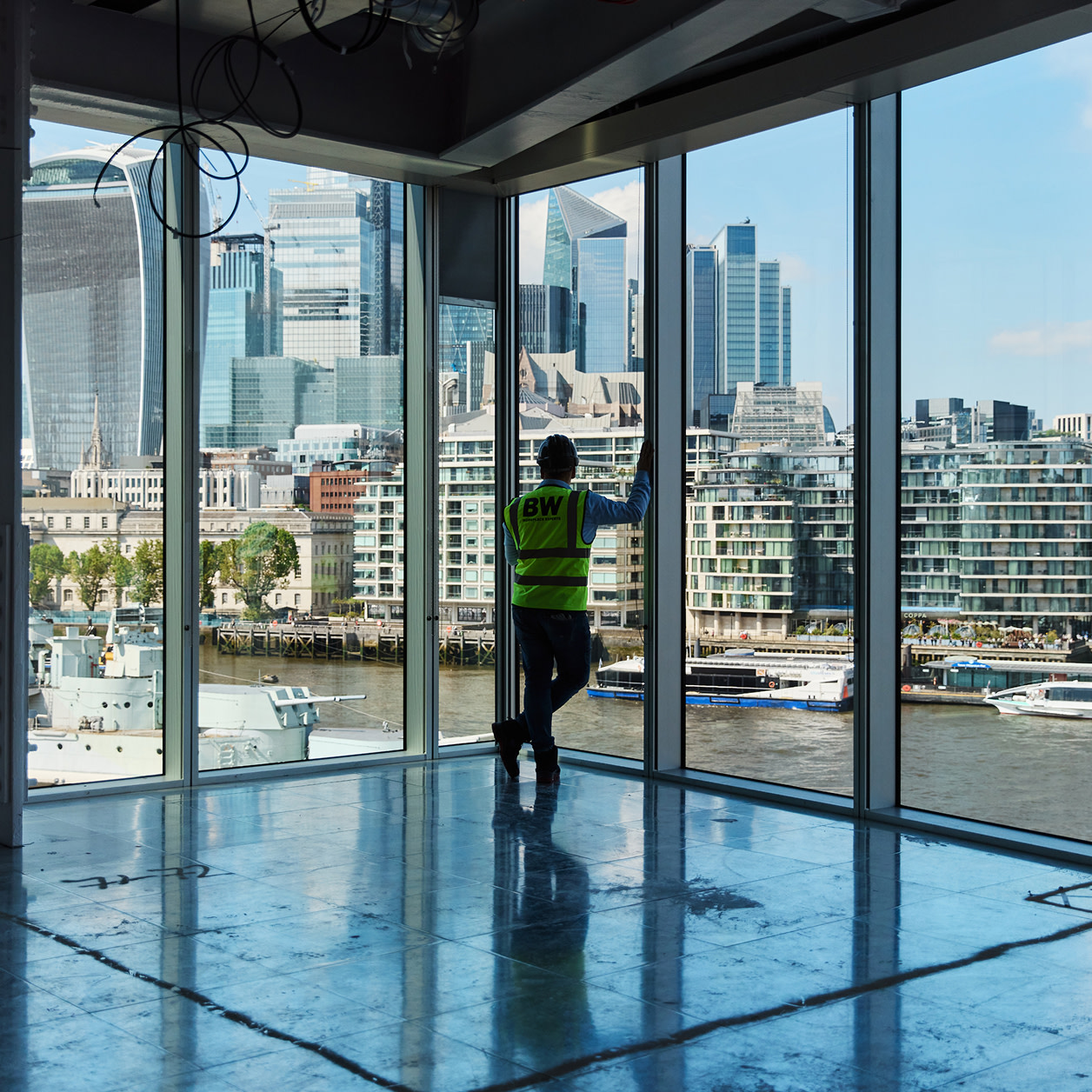 A contractor looking out from an empty building