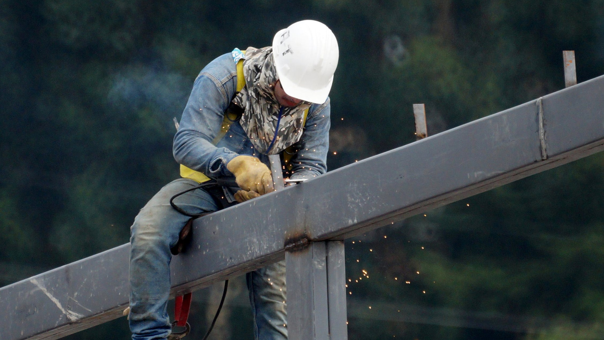 A construction worker welding a column