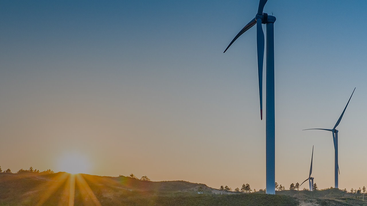 Three windmills at an open plain