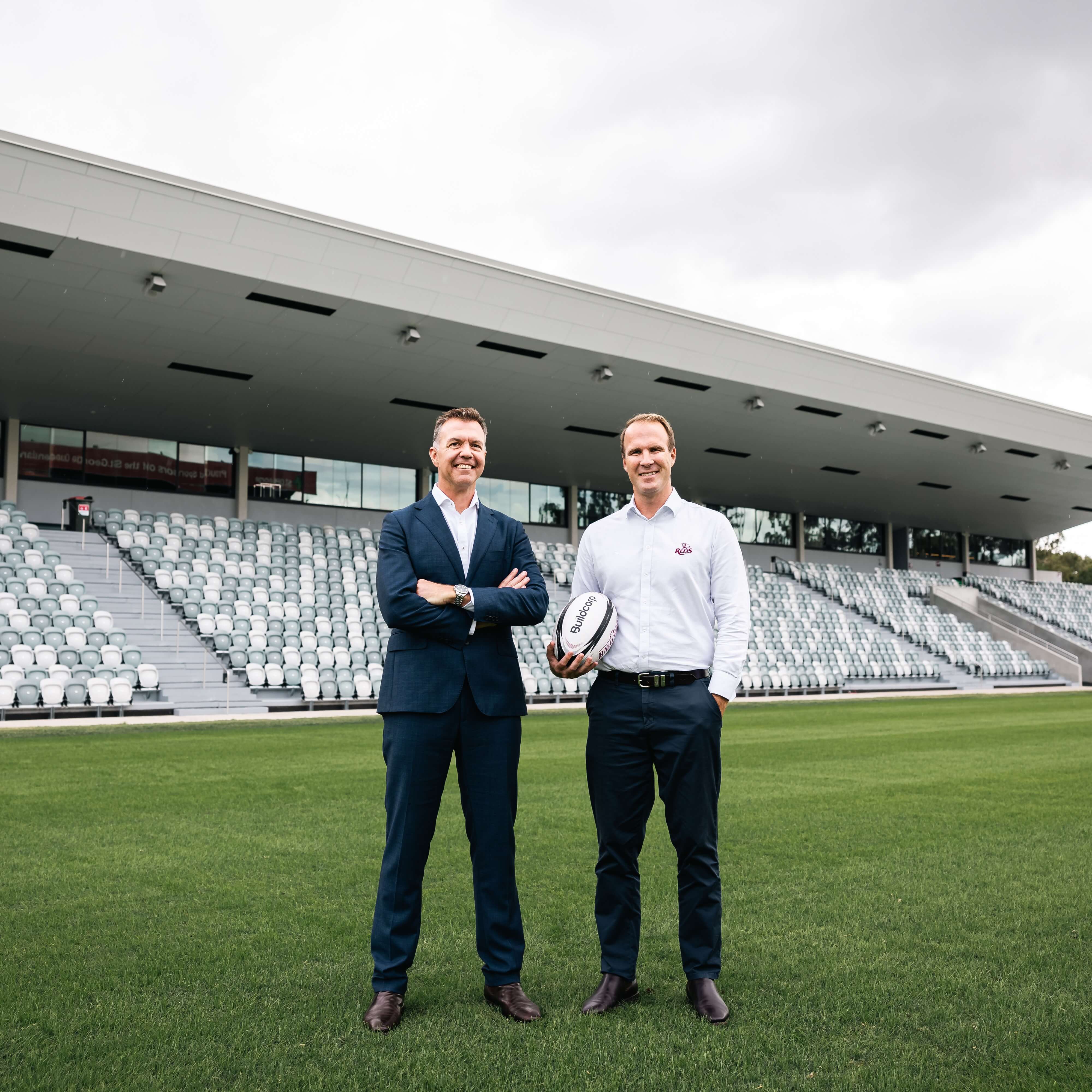 Two men standing on a rugby field