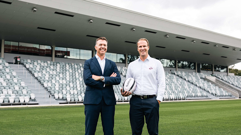 Two men standing on a rugby field