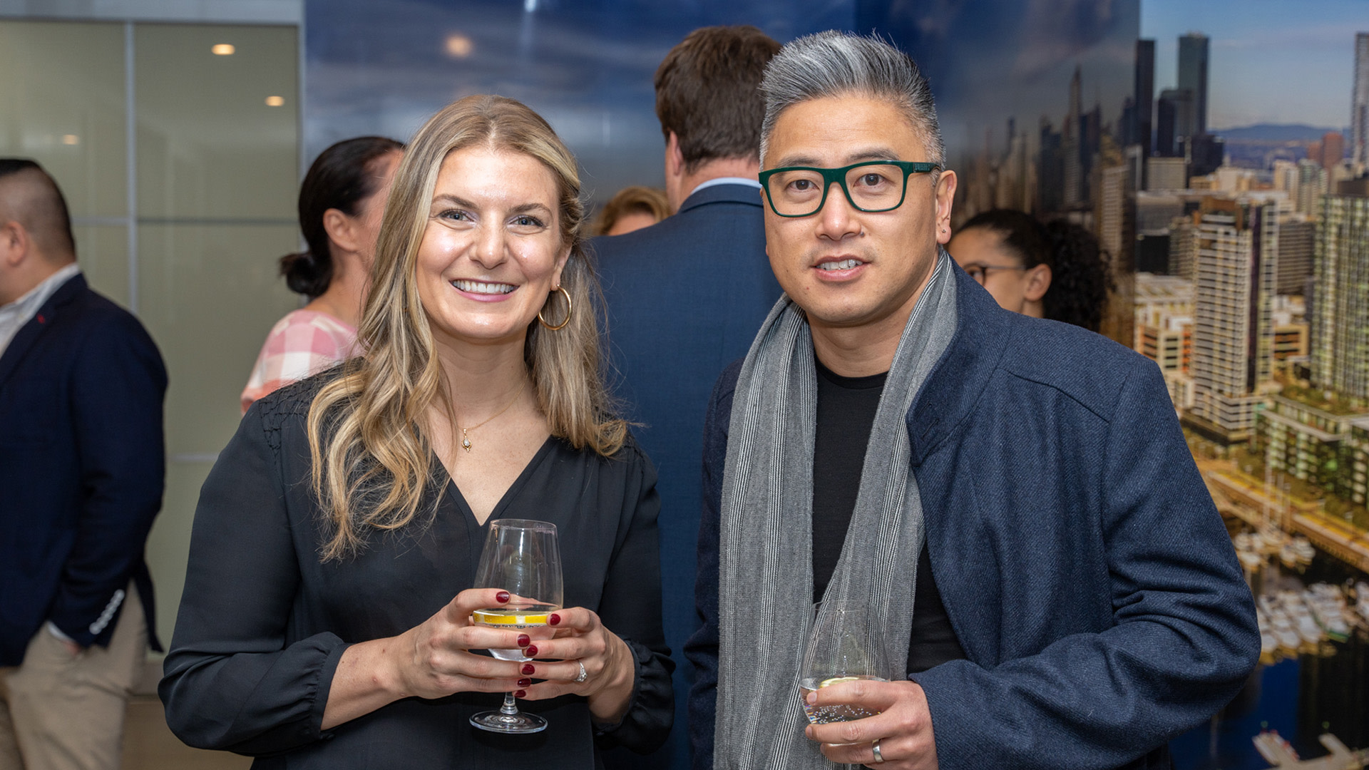 A man and a woman holding wine glasses posing for the camera