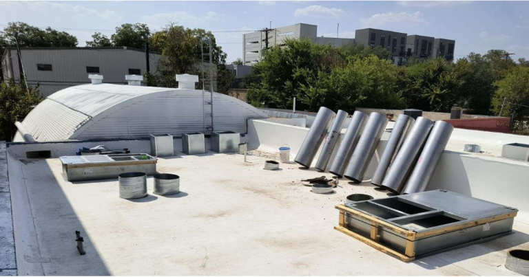 A roof with metal pipes on it