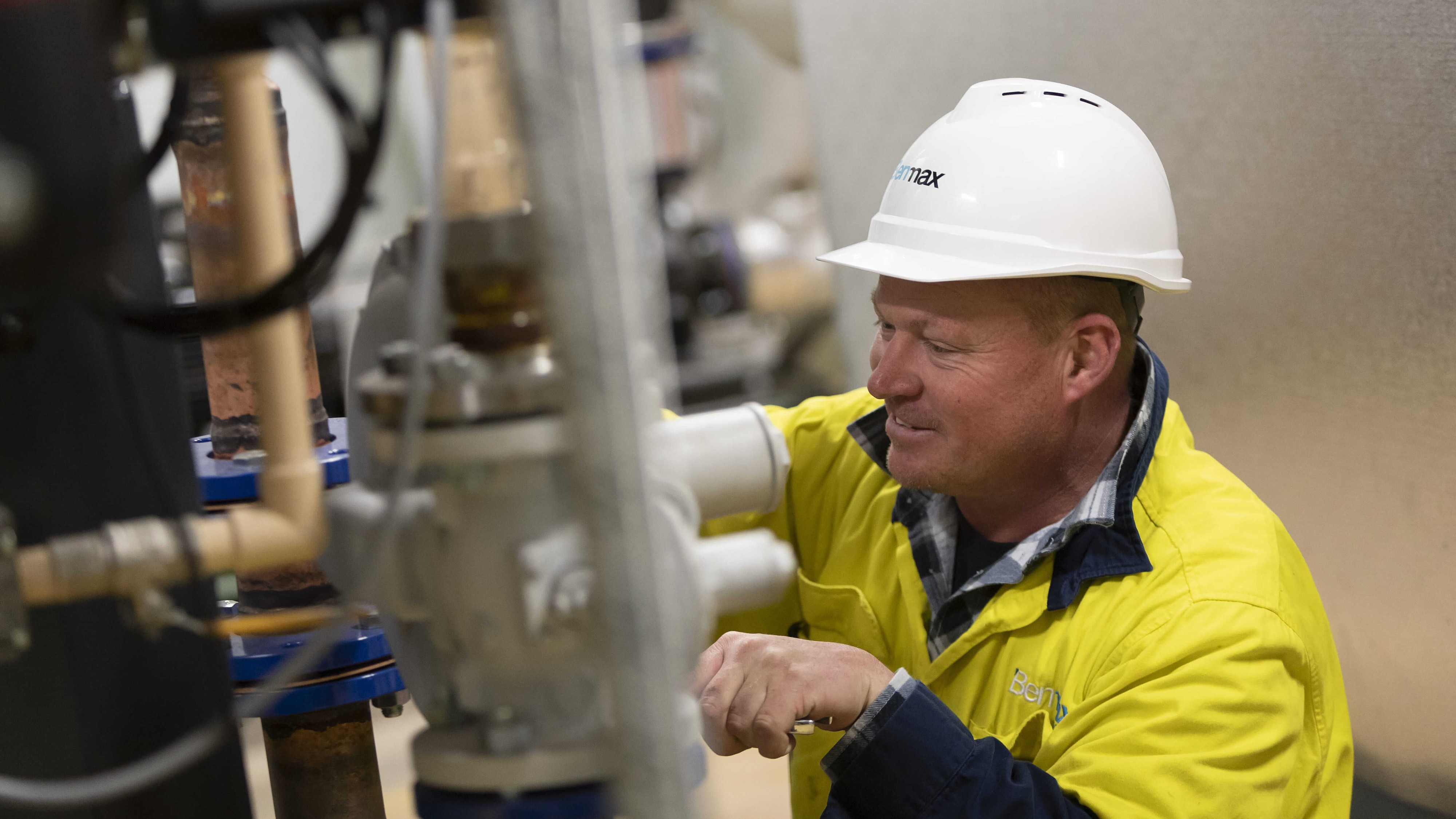 A construction worker fixing a pipe