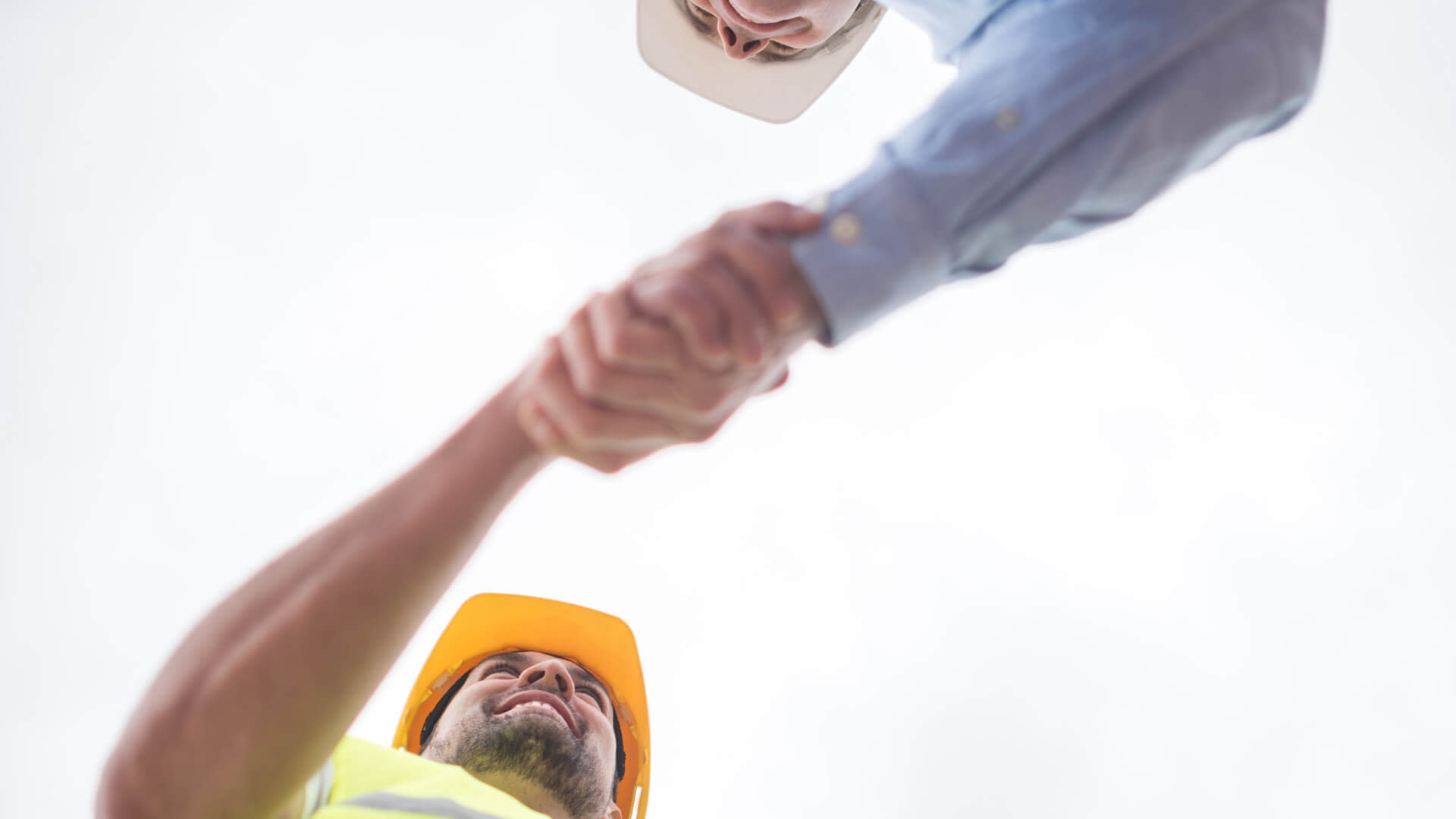 Low angle view of two contractors shaking hands