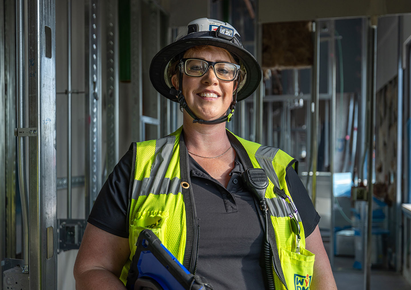 A woman construction worker smiling to the camera