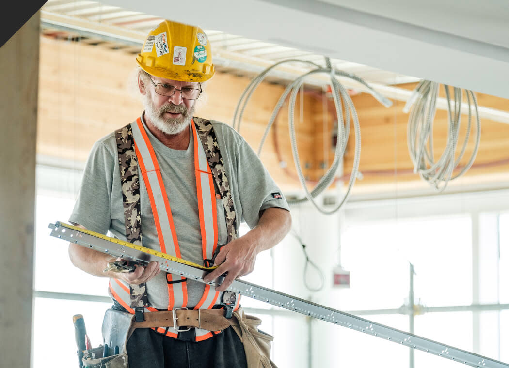 Subcontractor smiling to the camera wearing safety glasses