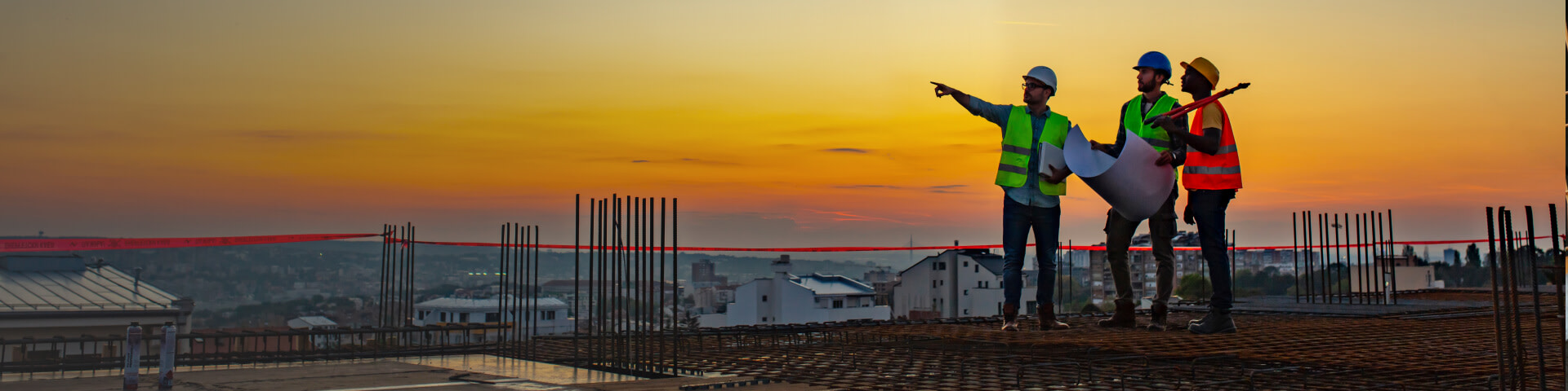 Workers on a jobsite at sun set