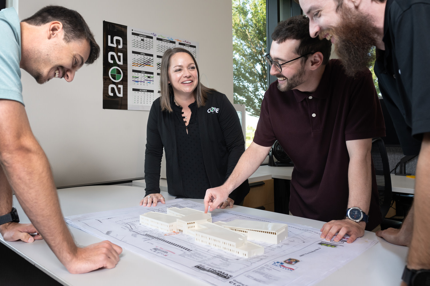 Core employees looking at blueprints 