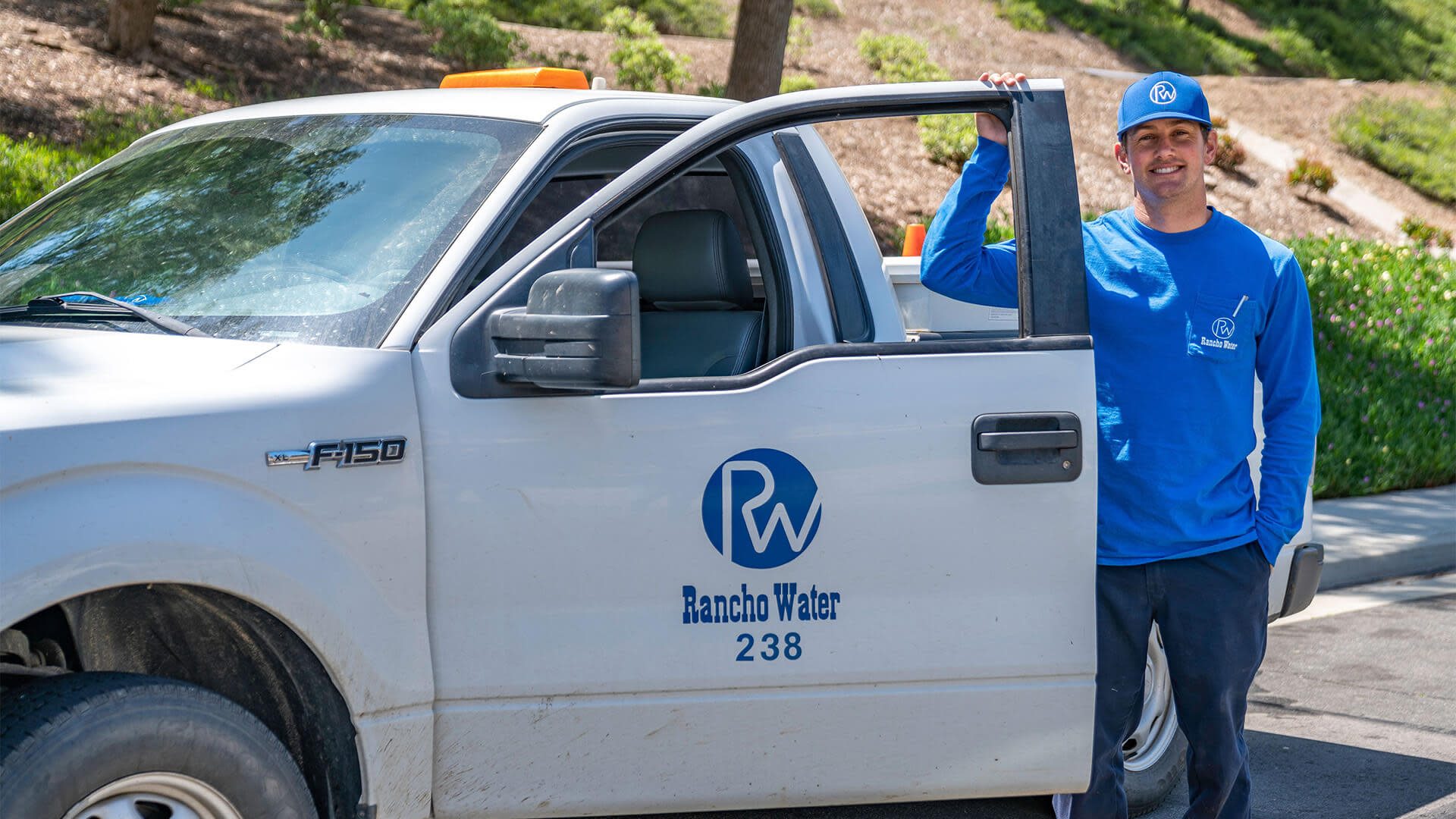 Rancho water worker standing outside of his truck