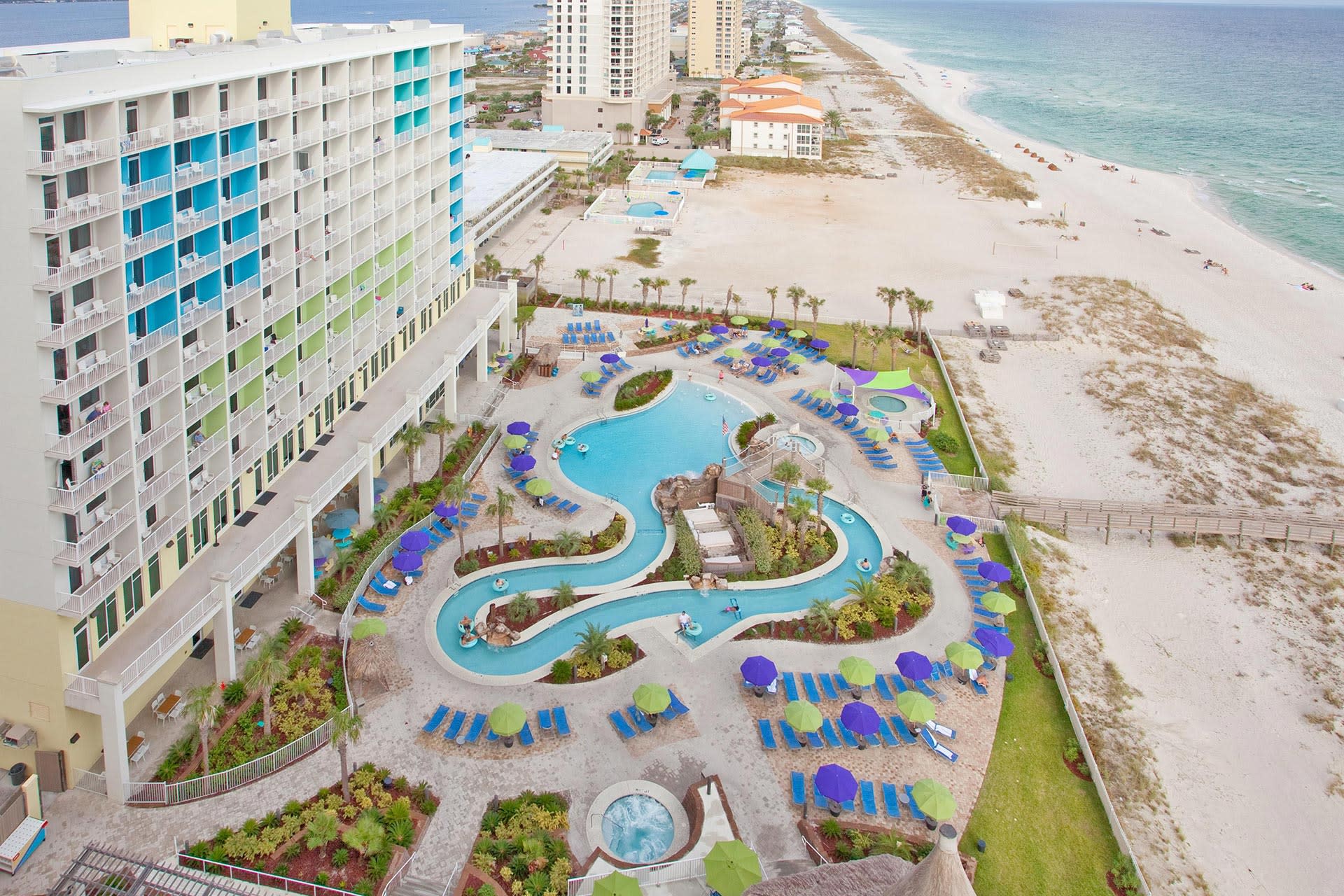 Aerial view of a hotel's pool area and ocean entrance