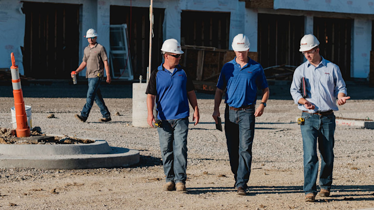 Contractors walking on construction site
