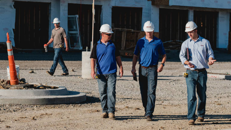 Contractors walking on construction site
