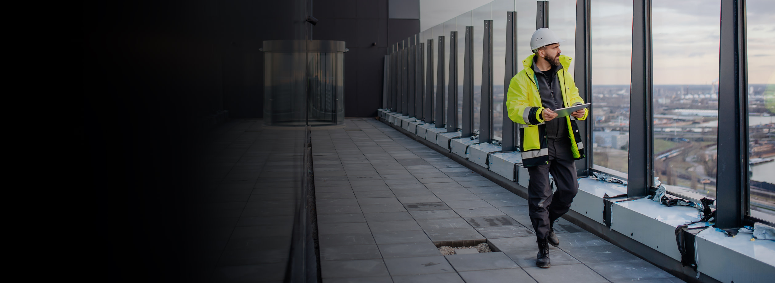 Contractor walking on a roof while holding a tablet