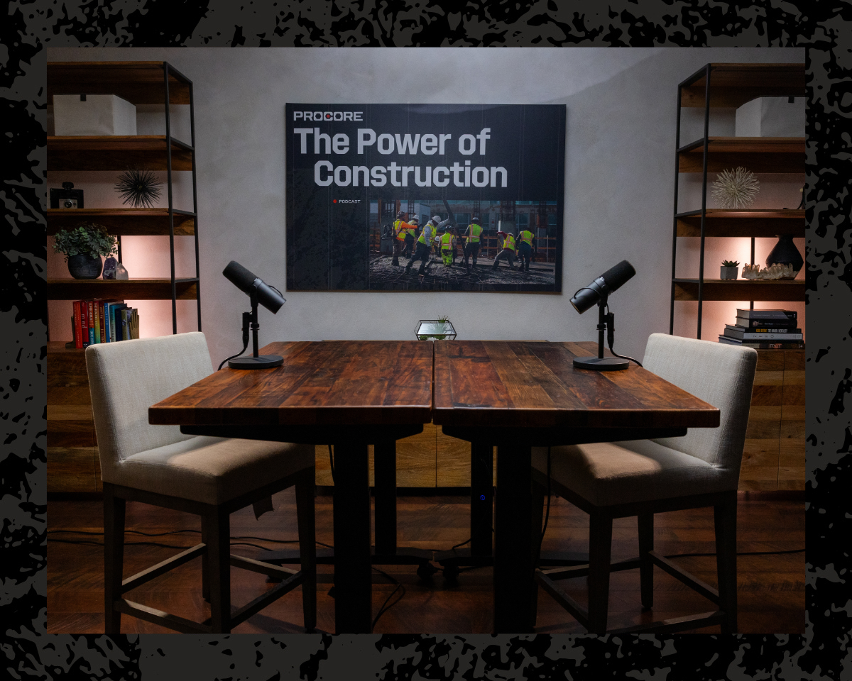 Construction workers standing up beams