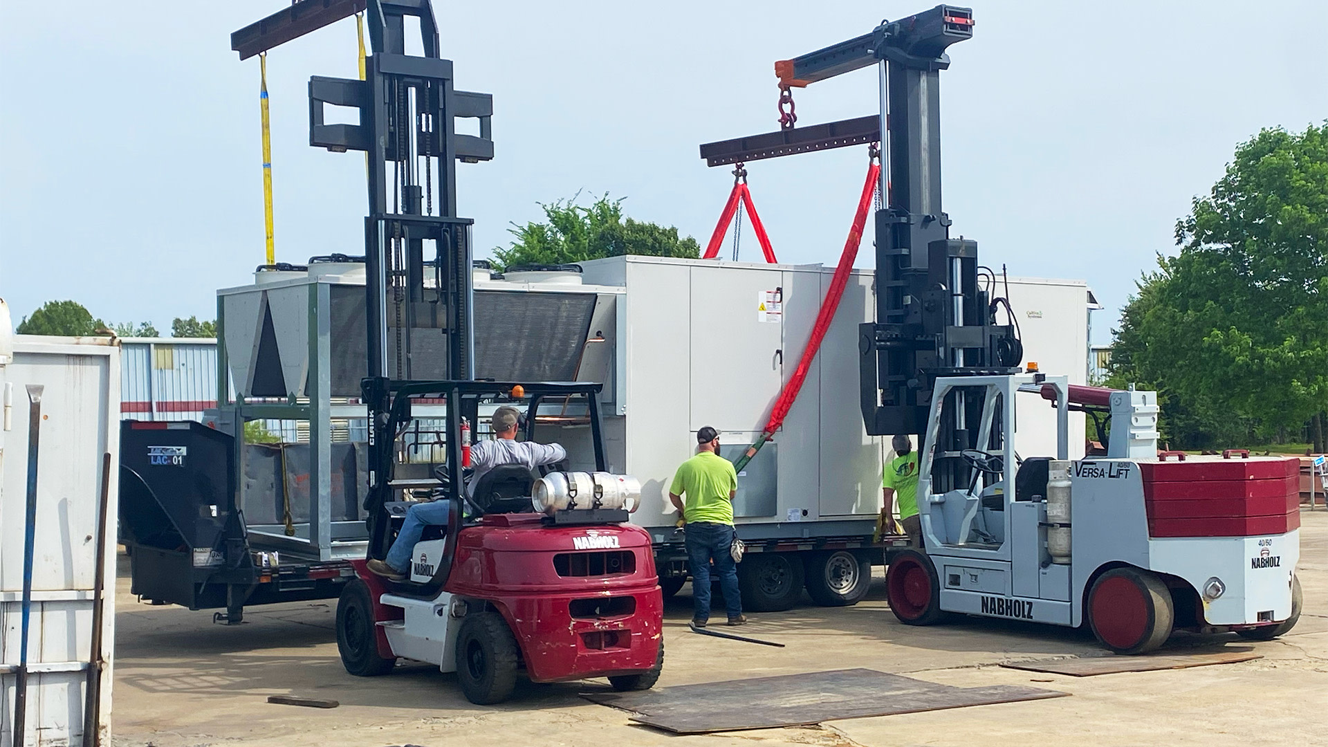 Men handling forklift trucks