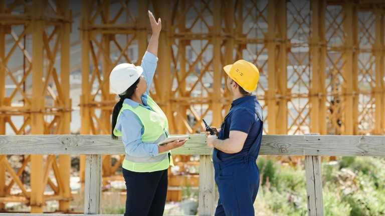 A woman and a man looking up at a construction