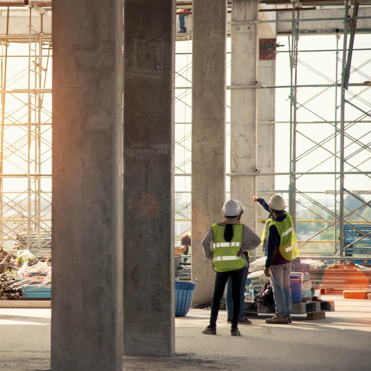 Construction workers inspecting a column