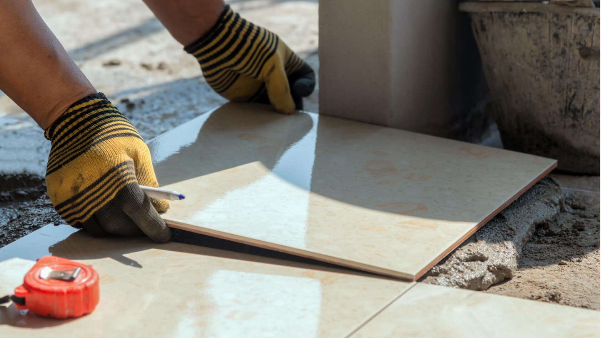 Construction worker placing a tile on the floor