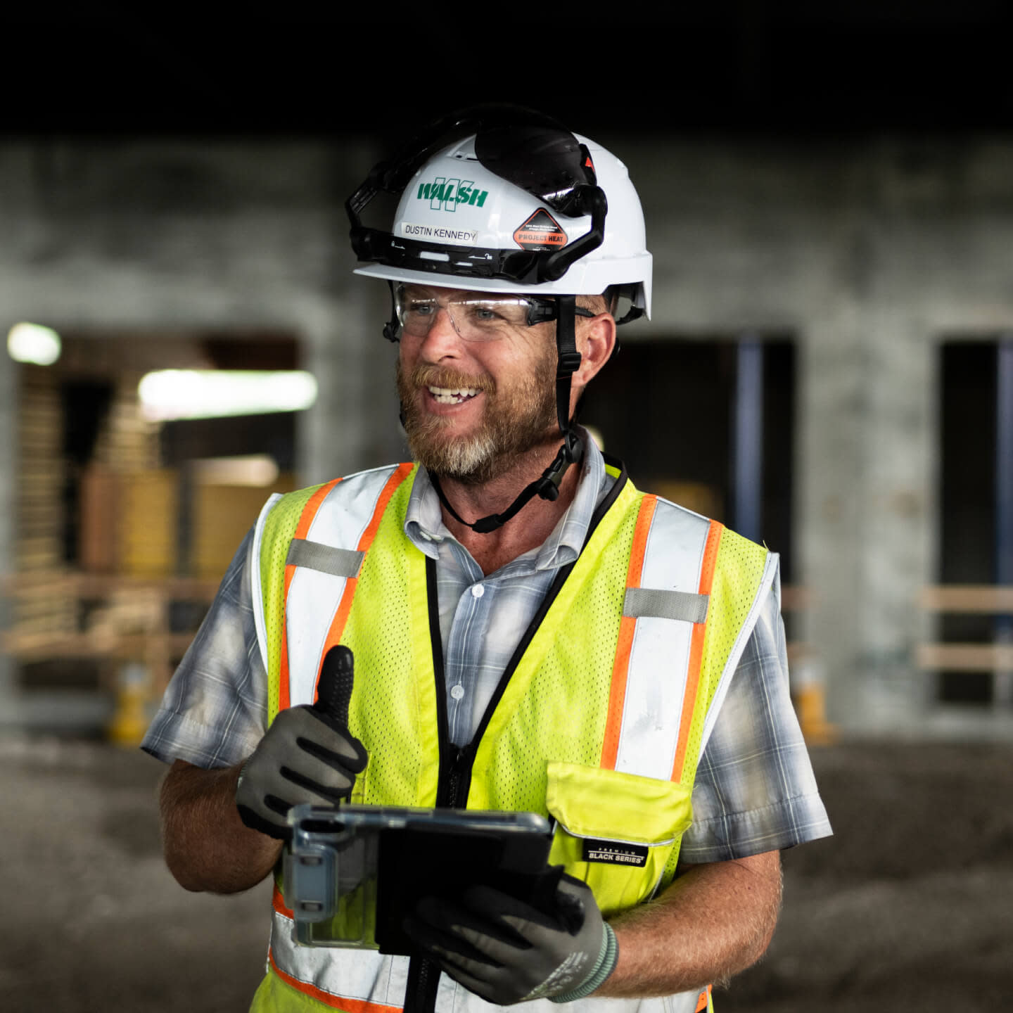 A contractor holding a tablet