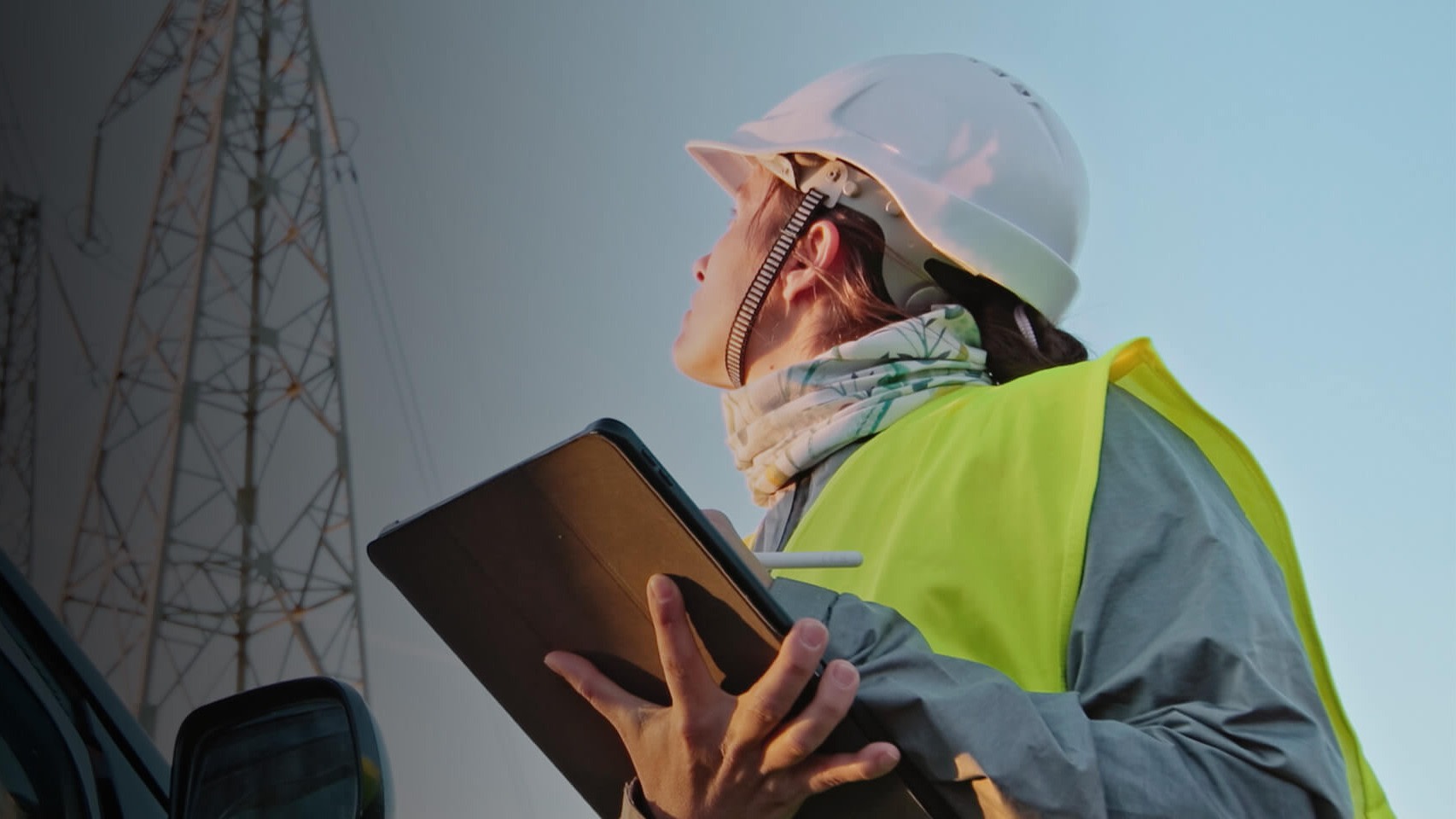 Contractor looking up while holding a tablet
