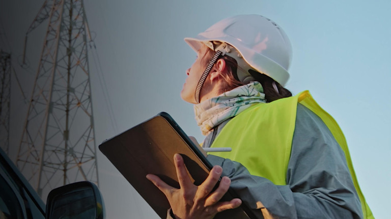 Contractor looking up while holding a tablet