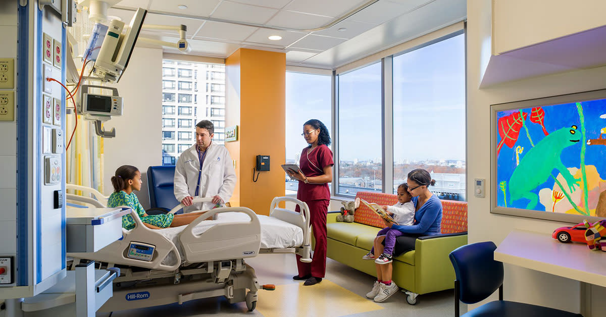 Patient with his family and doctor in a room of the Children's Hospital