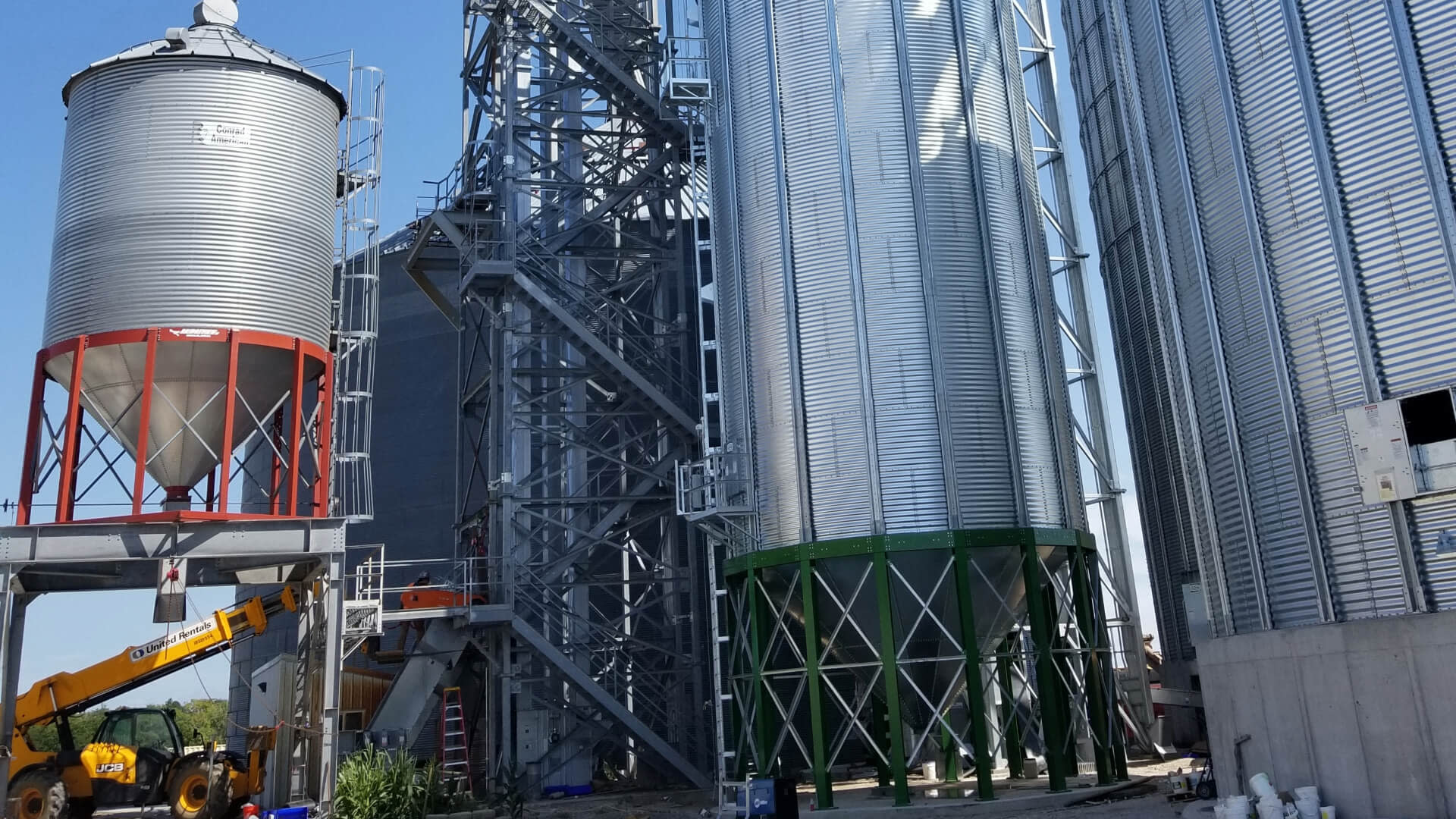 Large metal silos featured alongside a crane