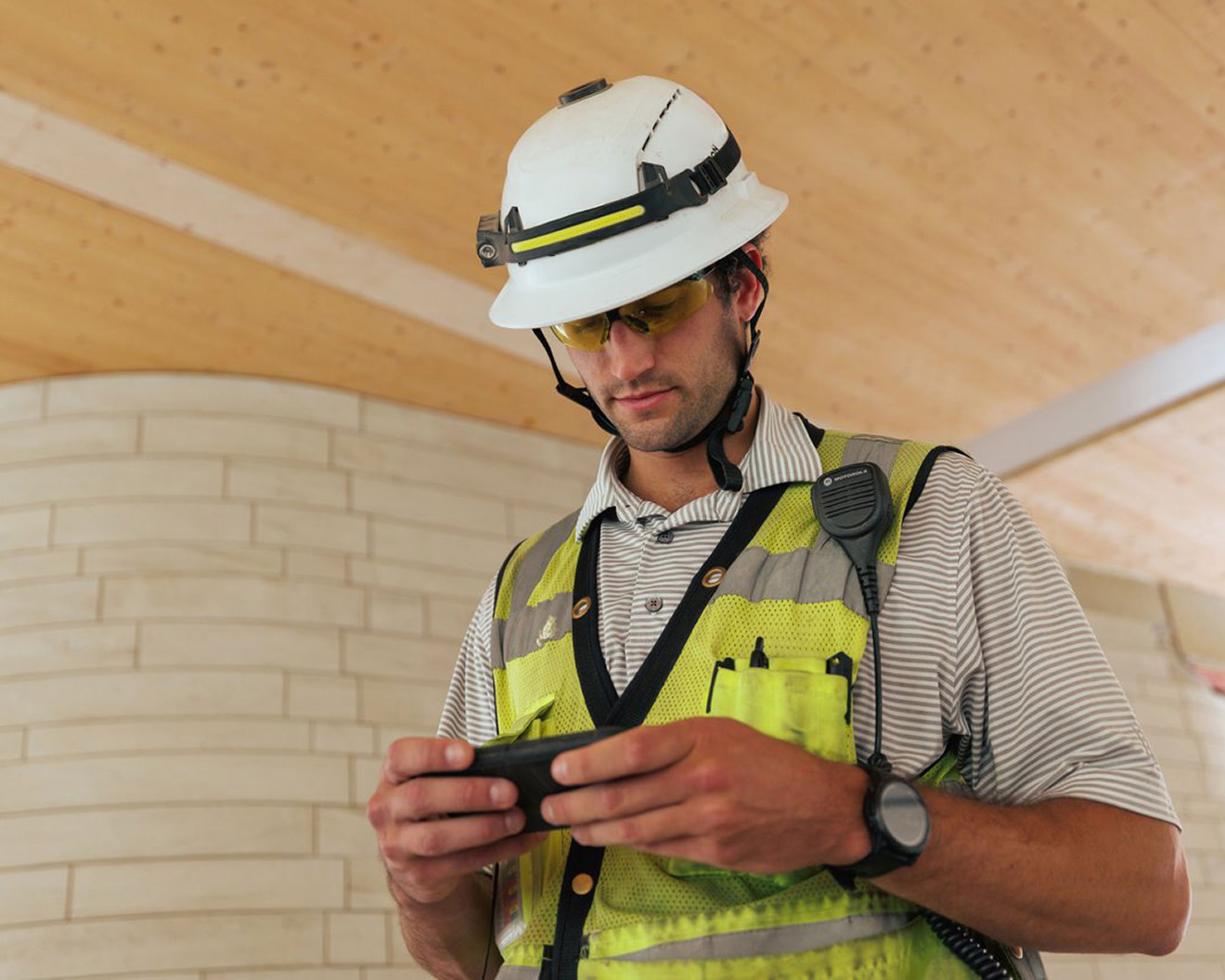 A woman using a tablet while inspecting a building