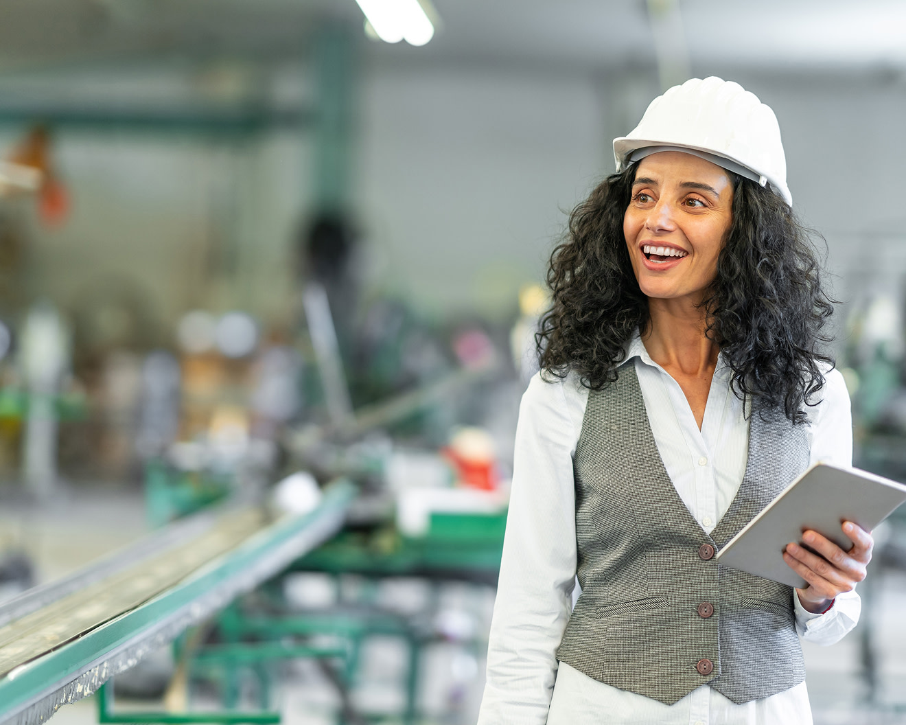 A woman using a tablet while inspecting a building