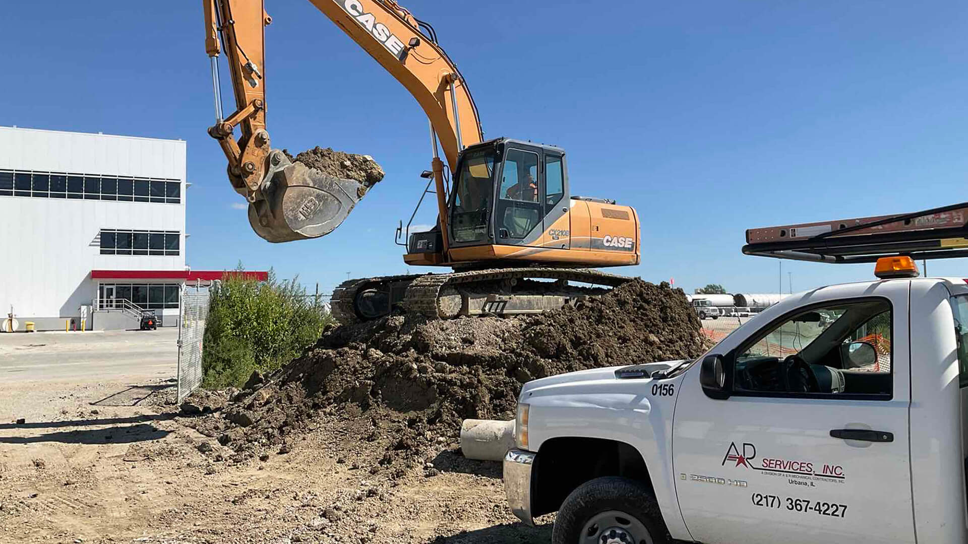 Construction worker moving dirt with an excavator