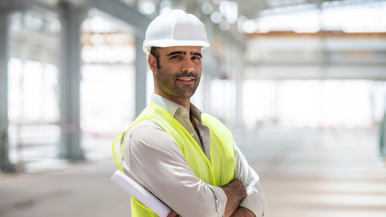 A contractor using a tablet on a construction site